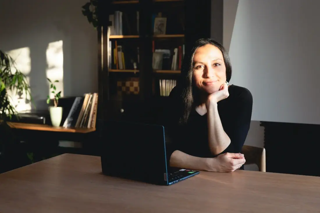 Woman sitting at desk with laptop